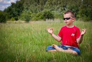You can feel fine after a heart attack Young boy meditating in a field.